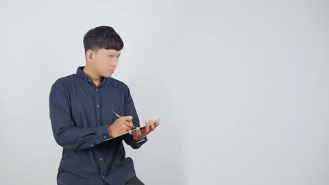Thoughtful Person Pausing While Writing in Notebook Video stock 344830485