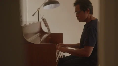 Thoughtful Piano Player Sits Playing Stock Footage 208782950