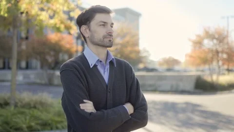 Thoughtful Professional Man Posing Confidently on a Bright Autumn Day Stock Footage 293679665