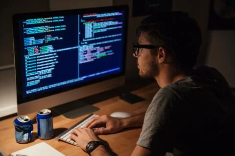 Thoughtful programmer coding in the evening at home Stock Photos