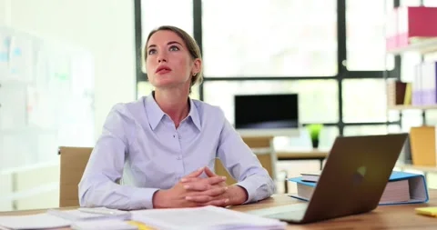 Thoughtful puzzled female worker thinking about solving problem at work Stock Footage 252115926