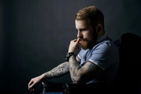Thoughtful red bearded man studio portrait on dark background Stock Photos