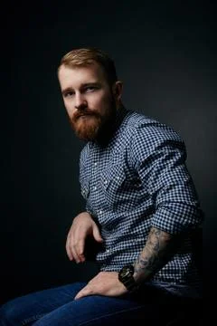 Thoughtful red bearded man studio portrait on dark background Stock Photos