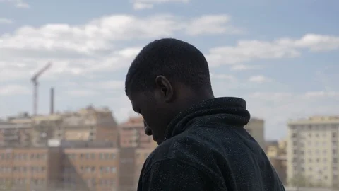 Thoughtful sad young american african man walking alone in the city Stock Footage