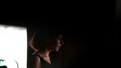Thoughtful sadding young girl walks around the apartment Stock Footage 72816342