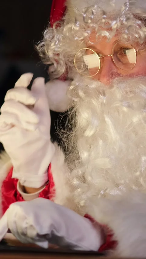 Thoughtful santa claus stroking his long white beard Stock Footage 323904853