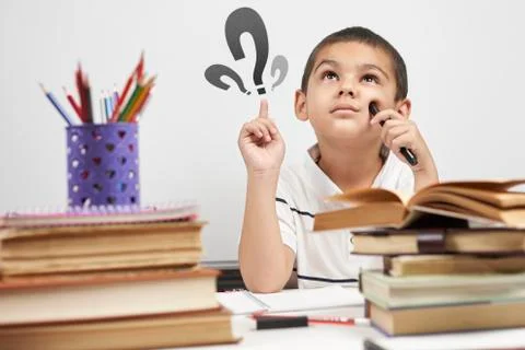 Thoughtful schoolboy having idea, raising finger. I know it Stock Photos