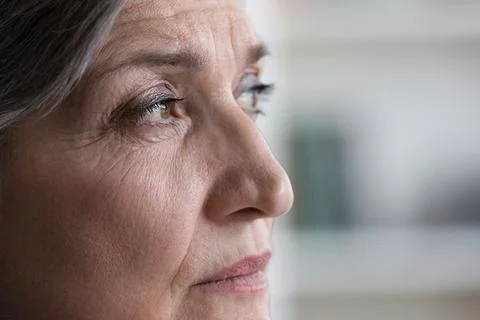 Thoughtful senior grey haired lady face with wrinkles Stock Photos