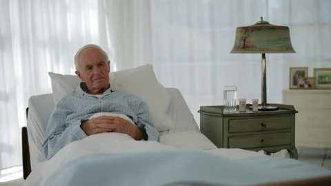Thoughtful senior man lying in bed. Видео 88342568