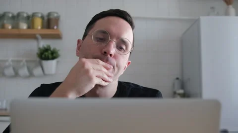 A thoughtful serious young Eupropean student writer sits at a home office desk i Stock Footage 152164980