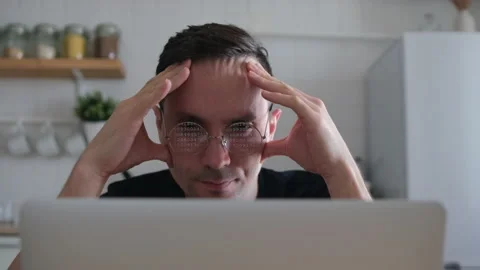 A thoughtful serious young Eupropean student trader sits at a home office table  Video stock 152166398
