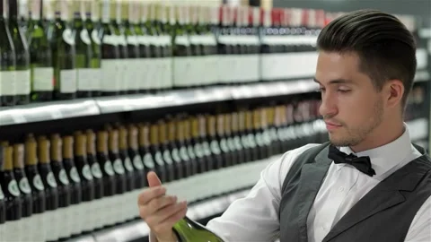 Thoughtful sommelier selecting the perfect wine Stock Footage 311918249