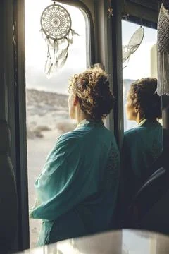Thoughtful standing back view of lady looking outdoors standing on camper van Stock-Fotos
