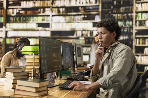 Thoughtful student looking at AI chatbot screen on desktop monitor Stock Photos