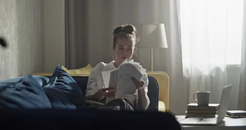 Thoughtful student reading papers and preparing for session Stock Footage 172142819