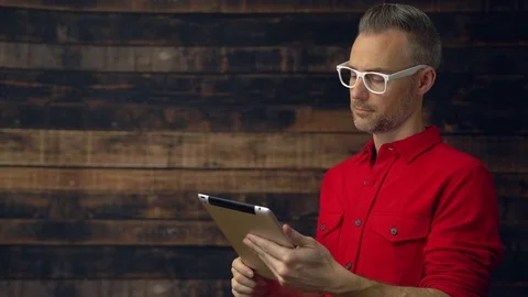 Thoughtful tablet using hipster is serious Stock Footage 85437109
