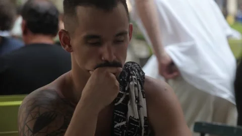 Thoughtful Tattooed Man Contemplating Next Move in Outdoor Chess Game Stock Footage 341323628