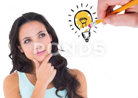 Thoughtful woman looking at drawn innovation bulb against white background Stock Photos