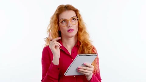 Thoughtful woman taking notes Stock Footage 236420356