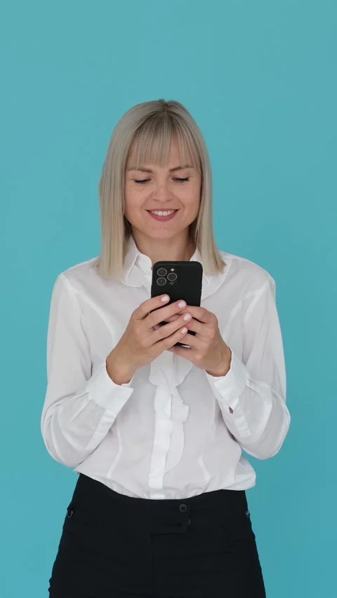 Thoughtful Woman Using Smartphone For Texting On Blue Background Stock Footage 274589837