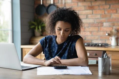 Thoughtful young black woman count tax rate before pay online Stock Photos