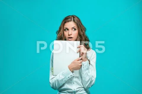 The thoughtful young business woman with pen and tablet for notes on blue Stock Photos