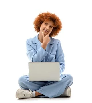 Thoughtful young female programmer with laptop sitting on white background Foto stock