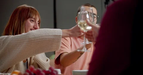 Thoughtful young Hispanic friends having cozy dinner and clinking wine glasses Stock Footage 123668264