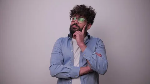 Thoughtful young man with beard thinking deeply Stock-Footage 346989705