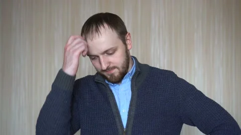 Thoughtful young man standing by the wall Stock Footage 103114842