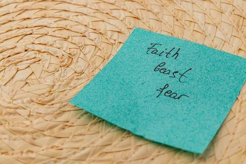 Thoughts on a blue sticky note resting on a woven surface Stock Photos