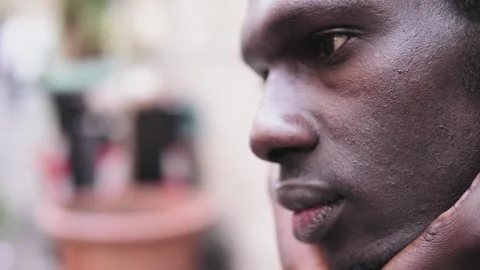 Thoughts, concern - worried  black man on the street closes his eyes thinking Stock Footage 240326974