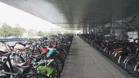 Thousands of bikes at the bike parking space near Amsterdam central station Stock Footage 89730568