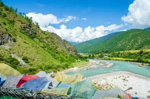 Thousands of colorful prayer flags flapping in the gushing wind from the susp Stock Photos