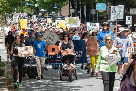 Thousands display signs while walking in Atlanta Hands Off march Stock Photos