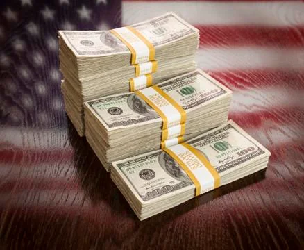 Thousands of Dollars Stacked with Reflection of American Flag on Wooden Table Stock Photos