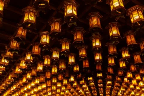Thousands of lanterns hanging on the ceiling of Buddhist temple Shrine. Stock Photos