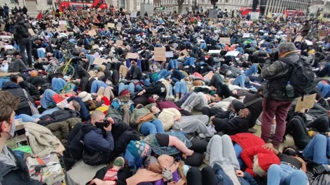 THOUSANDS LIE DOWN ON GROUND IN PARLIAMENT SQUARE AFTER SARAH EVERARD DEATH Stock Footage 150338895