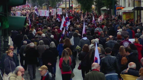 Thousands of people with flags marching down street Stock-Footage 140554202