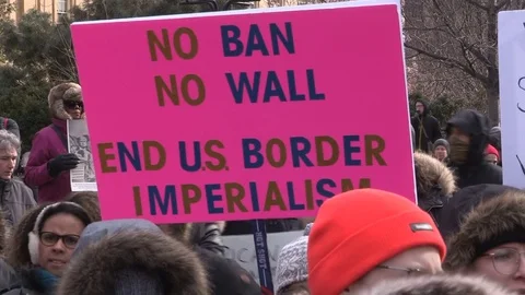 Thousands of people marching and protesting against Donald Trump Muslim ban Stock Footage