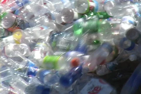 Thousands of plastic bottles pour out of a container in a recycling Video stock 552631