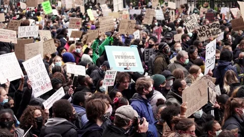 Thousands of protesters marching with signs, banners at Westminster square Stock Footage 132101789