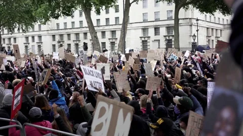 Thousands of protesters marching with signs, banners at Westminster square, H Stock Footage 132101794