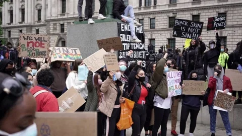 Thousands of protesters marching with signs, banners at Westminster square Stock Footage 132101795