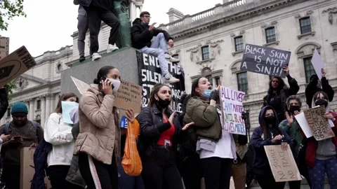 Thousands of protesters marching with signs, banners at Westminster square Stock Footage 132101830