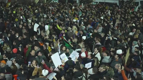 Thousands of protesting Bulgarians with flags jump in the center of Sofia Stock Footage 324561107