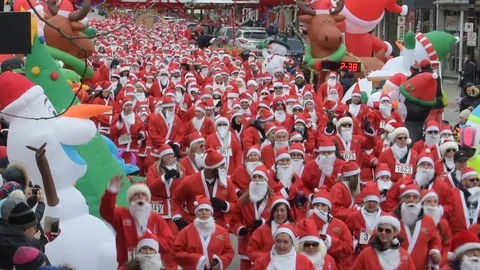 Thousands of Santa's Run During Festive Race 스톡 동영상 104376571