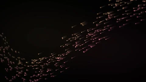 Thousands of soft pink particles sweep through dark space in curving ribbon.. 库存影片 347289863