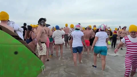 Thousands take part in New Year's Day plunge in the North Sea, Ostende, BE - 04  Stock Footage 296904173