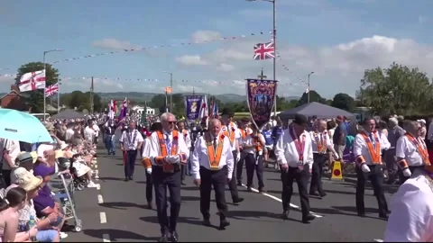 Thousands take to the streets for Orange Order parade in Royal Hillsborough
 Video stock 339440502